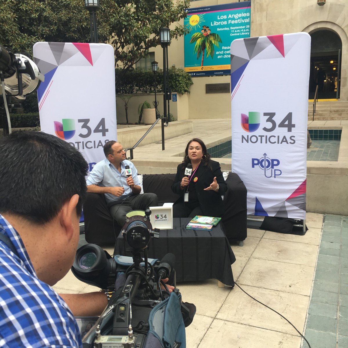 cameraman filming two people in conversation
