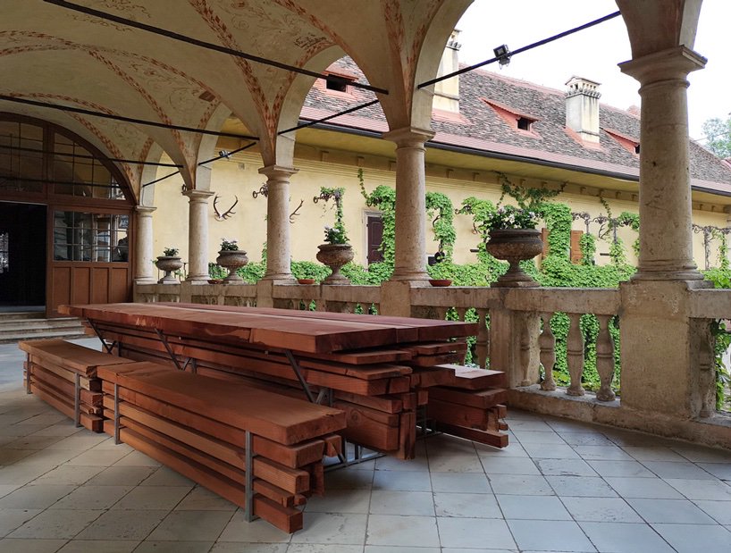 Design in the Woods | 6. This table and the benches were made by the Viennese designers Breaded Escalope by stacking planks of wood cut from a dead redwood sequoia tree struck by lightning in the grounds of Schloss Hollenegg. 
instagram.com/p/B28t_a3h_k2/
