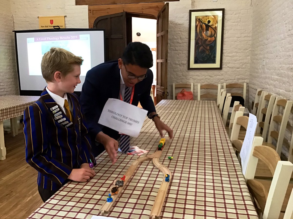 NewHallChaplain's tweet photo. Mr Baquiran is captivating visitors with the Trolley Cart Problem and an intense game of Theology Top Trumps! #BSiL @NewHallTheo https://t.co/pULPGxm62m