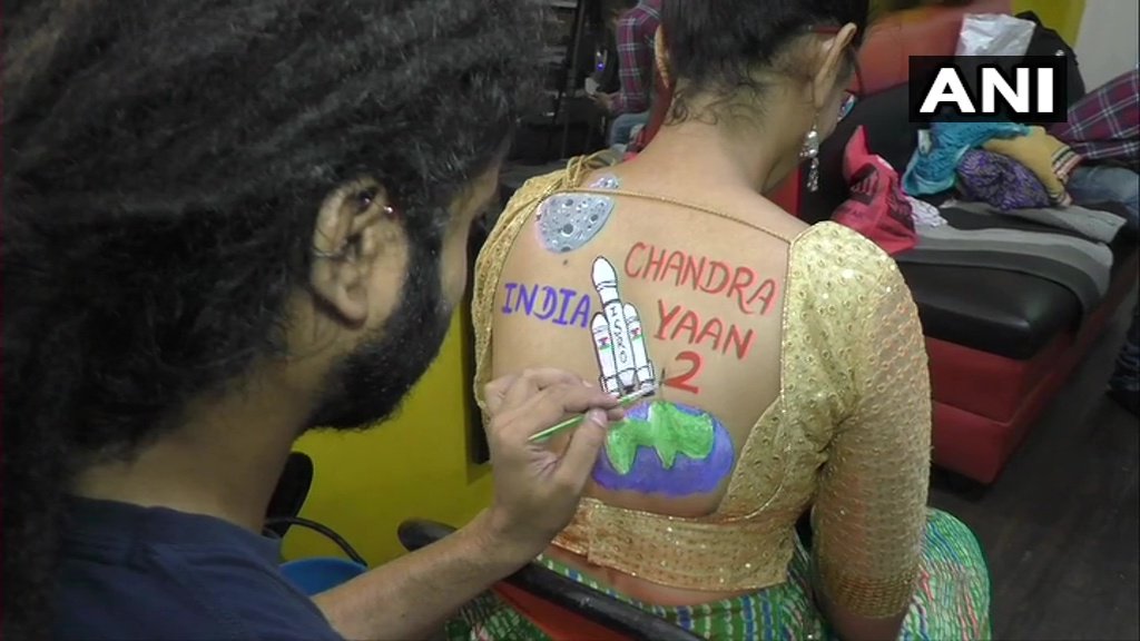 ANI's tweet image. Surat(Gujarat): Women pose with body paint tattoos during preparations for #Navratri and Raas Garba, yesterday