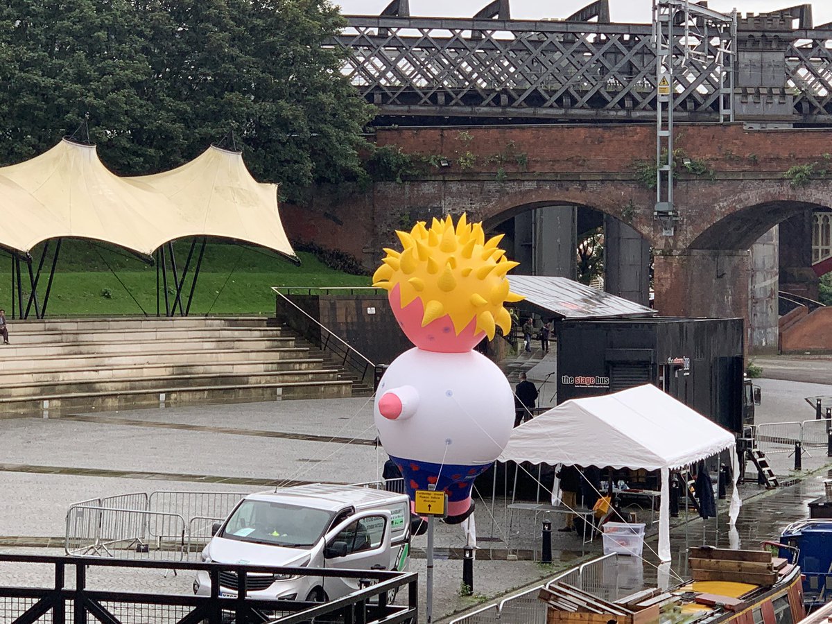 The giant Boris Johnson blimp is waiting for protestors as they finish their march at Castlefield Bowl.