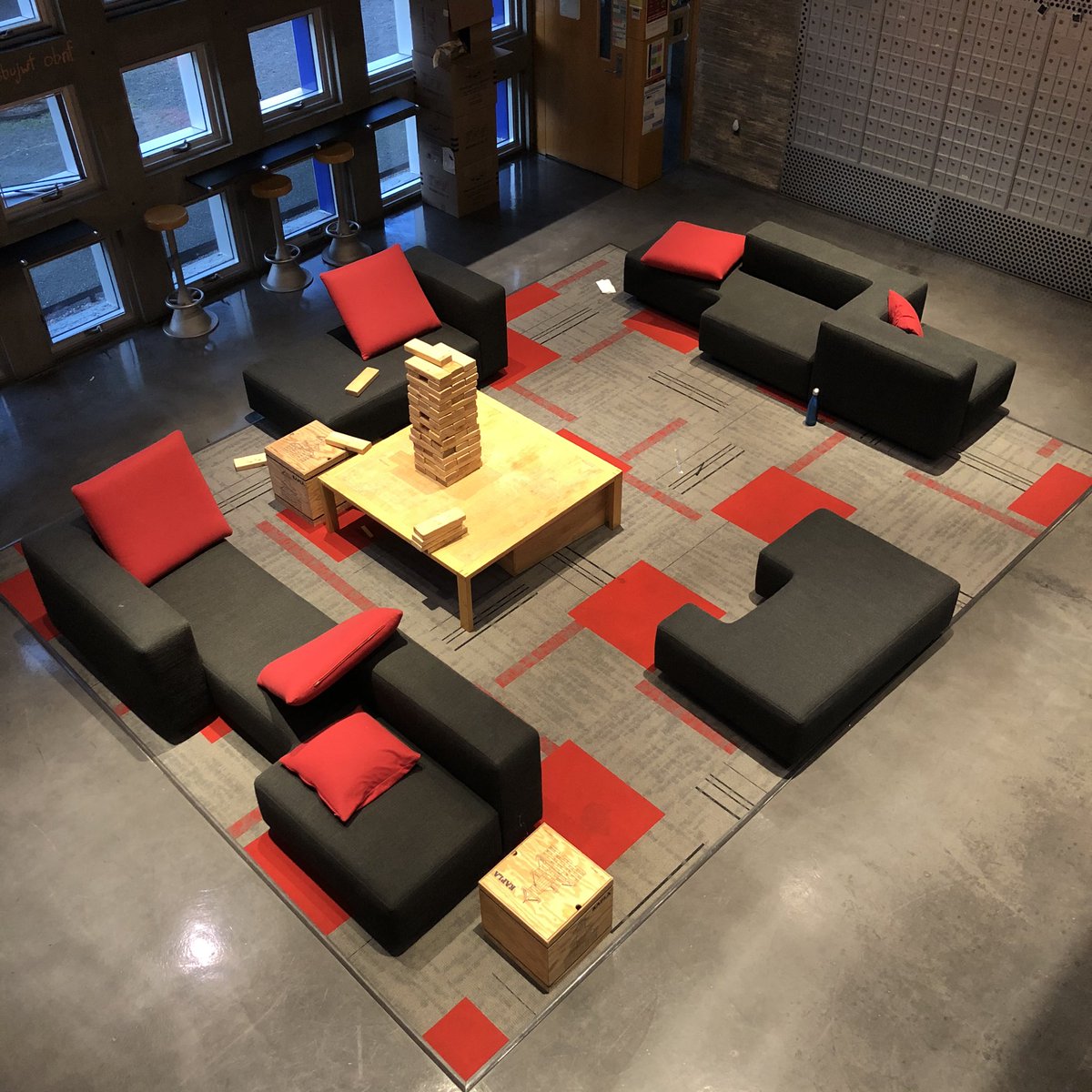 pearlli98's tweet image. The puzzle like shape of the sofa combined with the bright red square cushion and corresponding carpet patterns gives the section a toy-like nature. It creates a relaxing and playful atmosphere that the whole community can share. #communitybydesign #wherearethecolors