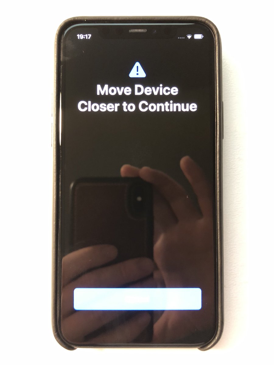 Photo of an iPhone stuck in the iOS migrator with the message "Move Device Closer to Continue" and a cancel button