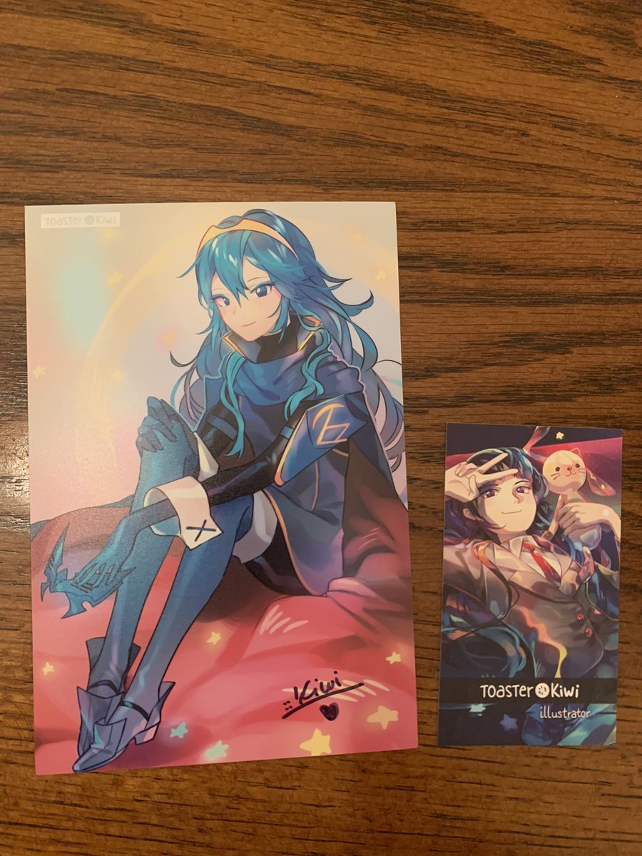 Last of the large prints is this one by <a href="/ninayoshida/">Nina Yoshida</a> which I bought at <a href="/ToasterKiwi/">🥝 Kiwi’s art</a>’s booth. Even if I could not get it signed I loved it when I saw it, and next to it is the mini print I got from Kiwi herself because I love how she draws Lucina