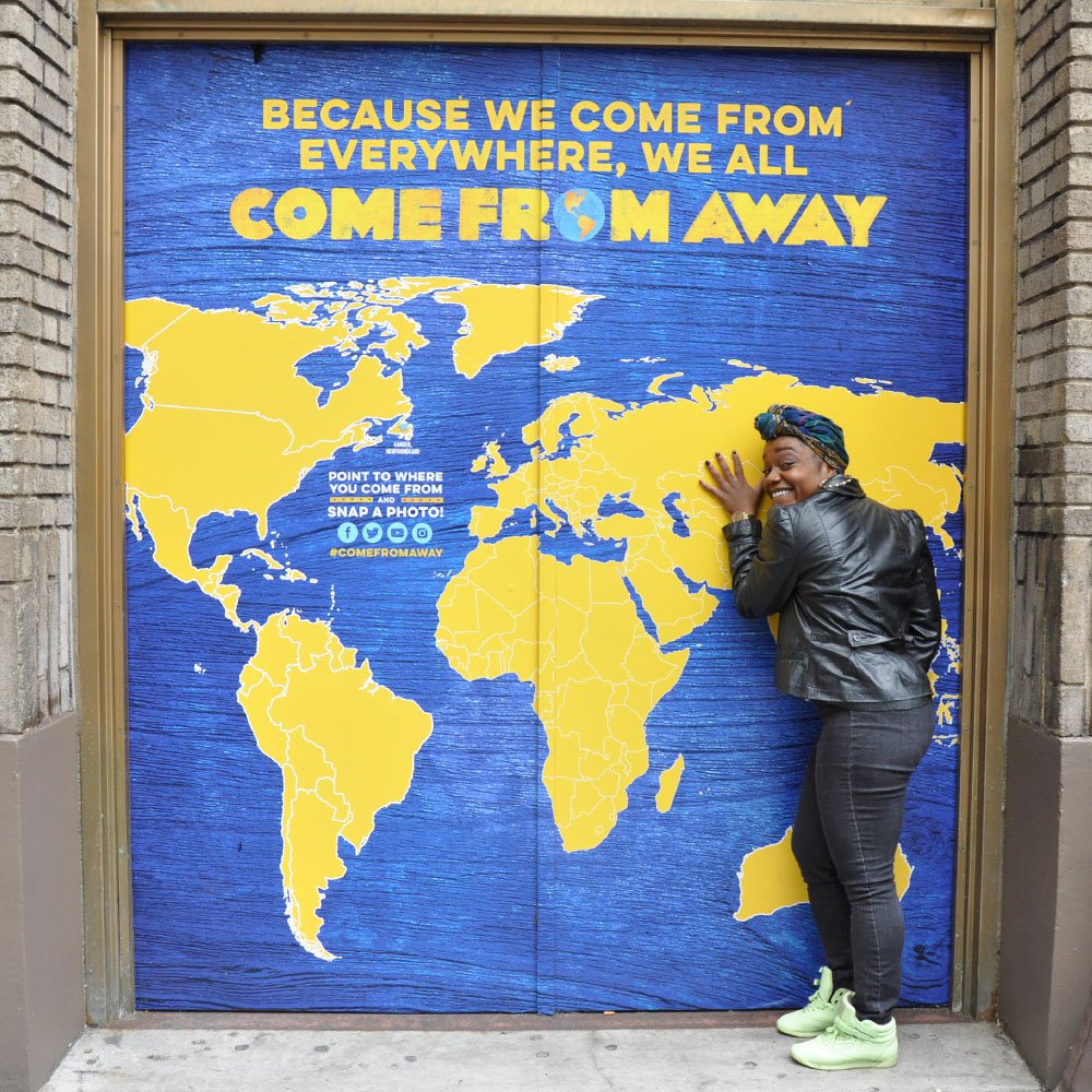 Kenita Miller hugging the door of the Schoenfeld Theatre