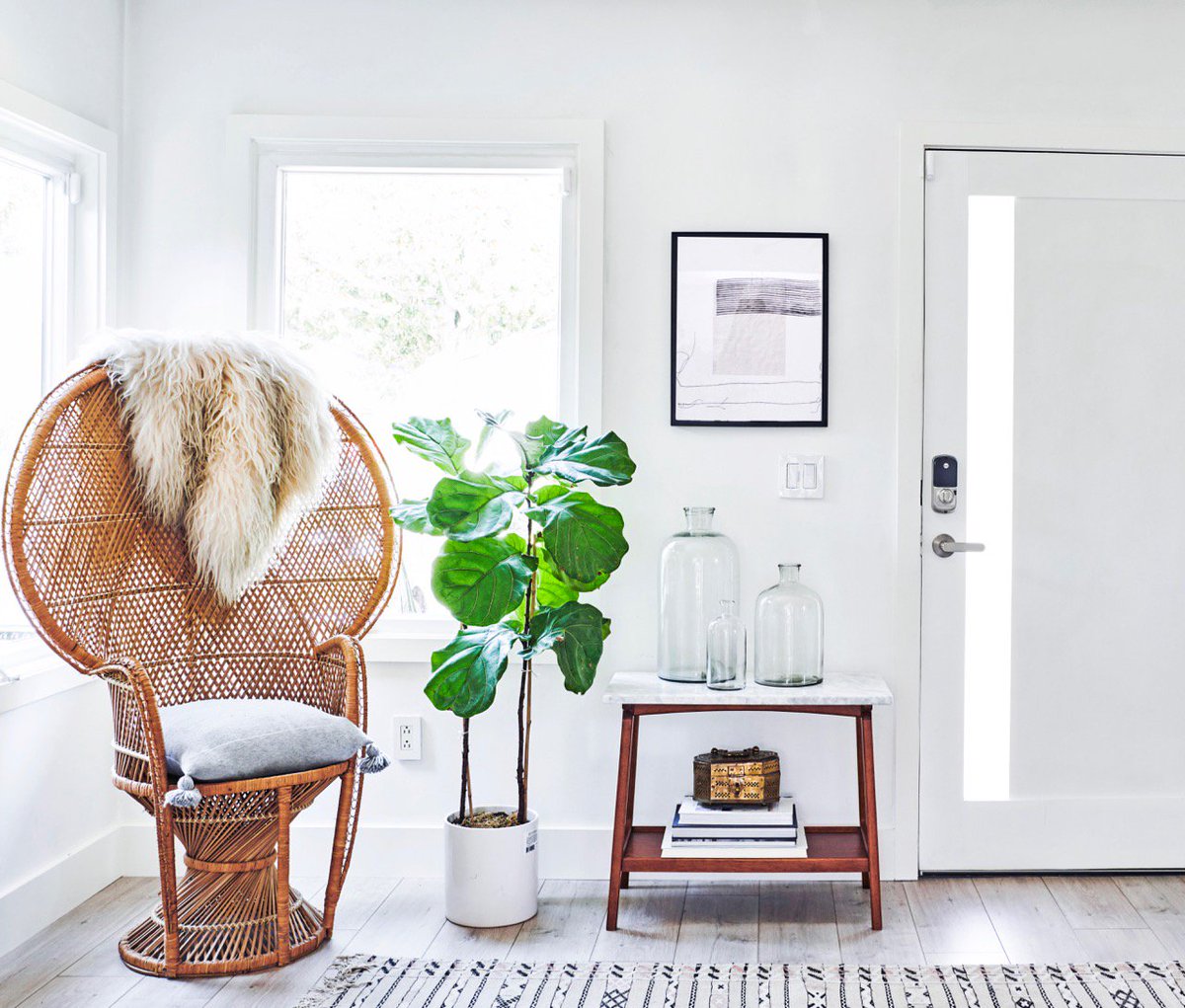 Featured: the home of Erika Wadler @homeslicehome: 'It's pretty incredible how you can completely change your entryway just by swapping out a chair. You can go from boho to mid-century with minimal effort.”  Also featured: Yale Assure Lock + Kincaid lever. #yalelocks #smartlocks