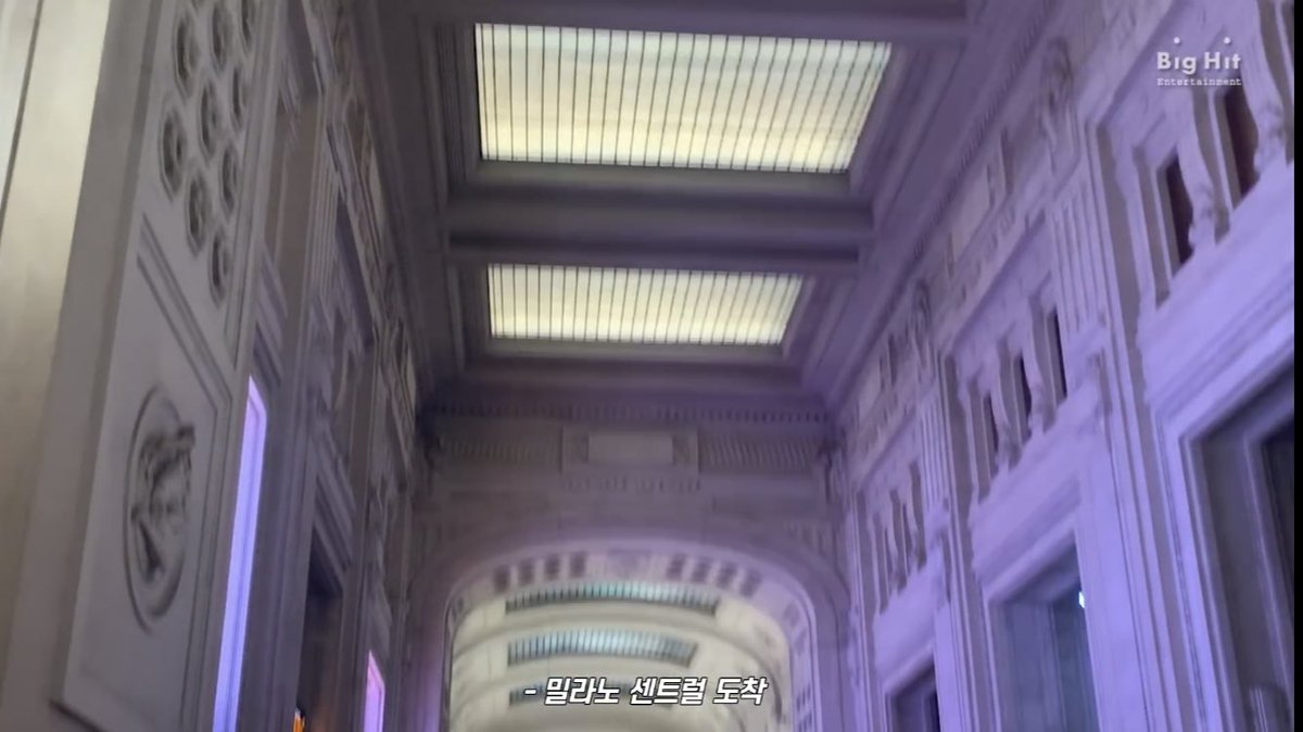 Our tour of Milan includes a baggage claim, a train, and the grandeur of Milan Central Station.