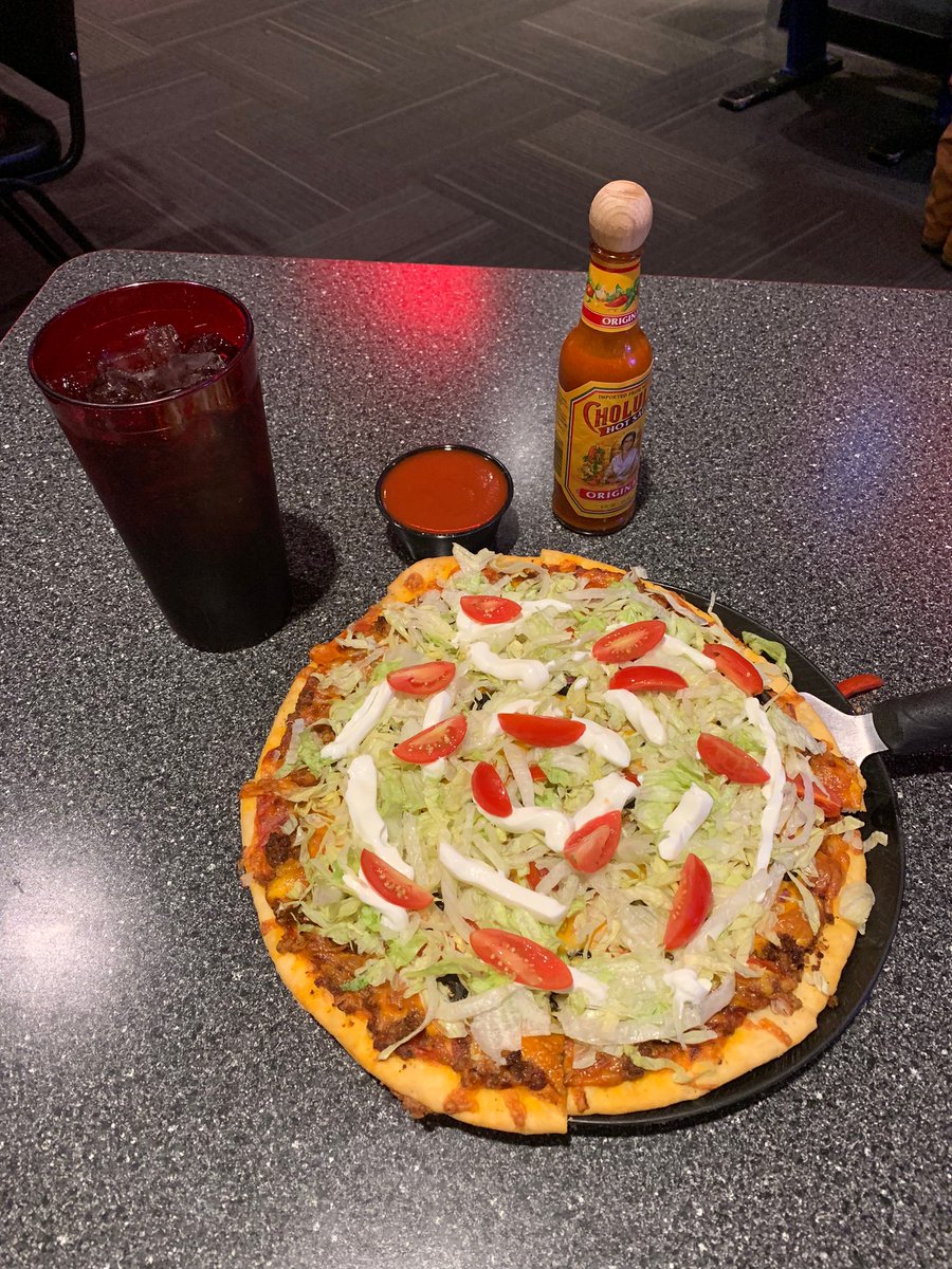 Happy #NationalTacoDay! Have you tried our taco pizza? It's the perfect mix of taco sauce, seasoned beef, red onion, black olives, tomatoes, cheddar cheese, lettuce, and sour cream. Come in and try one today!