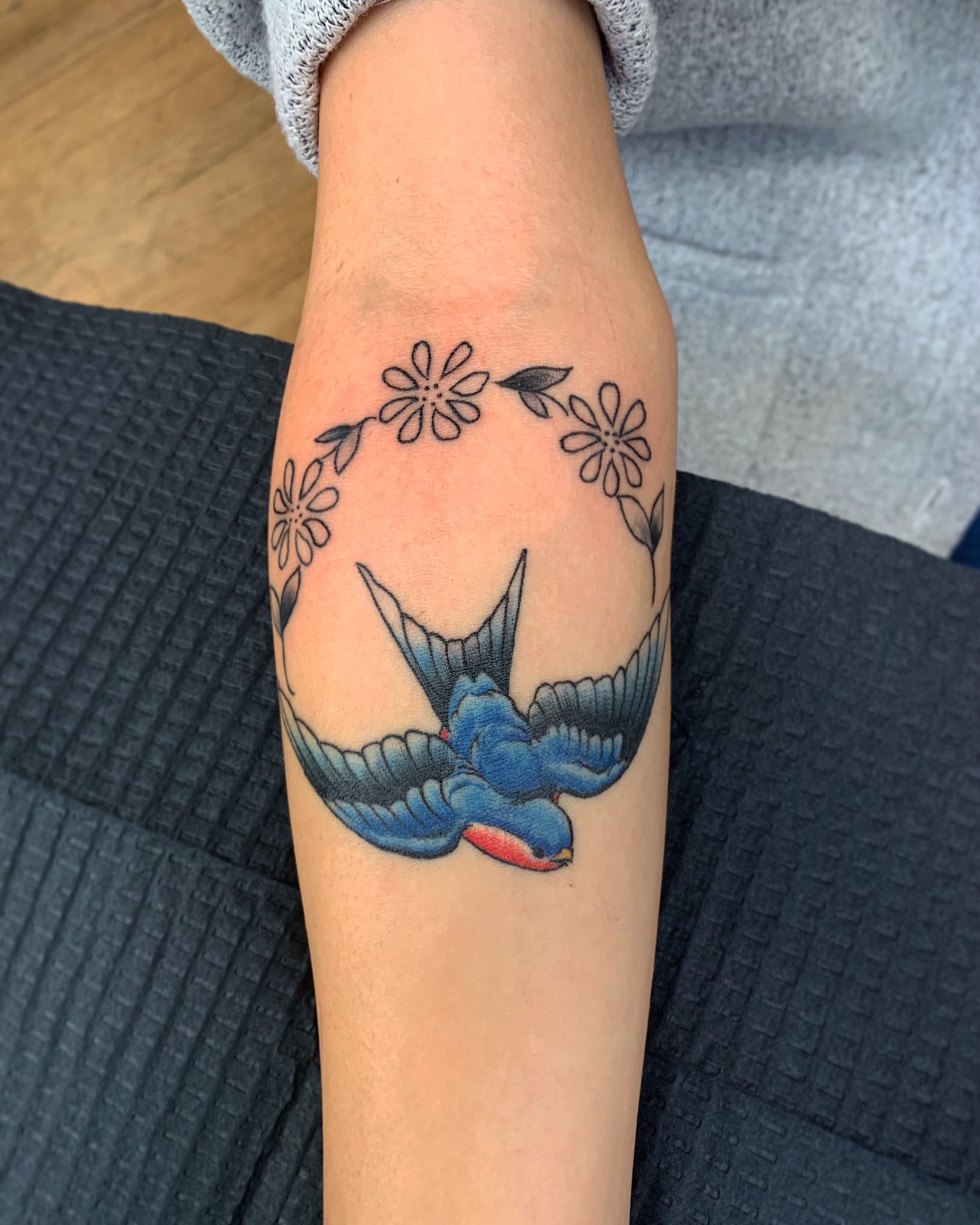 Watercolor style bluebird tattoo on the right side of