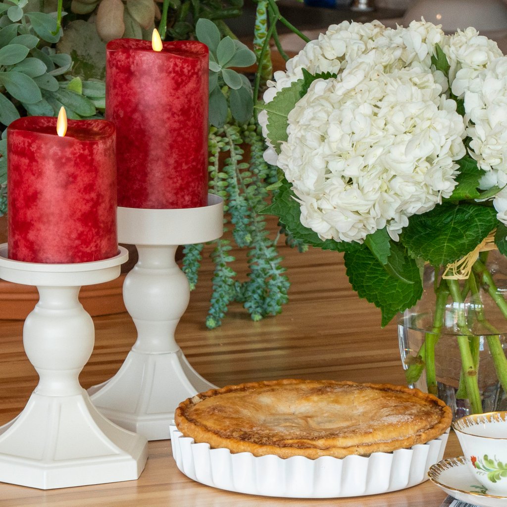 LuminaraLLC's tweet photo. The rich red of our Luminara Mottled Wax Pillars makes your decor standout all year round. We especially love the way they pop next to ivory flowers and accessories. How would you style these ruby colored candles? https://t.co/69fdYxE4sB