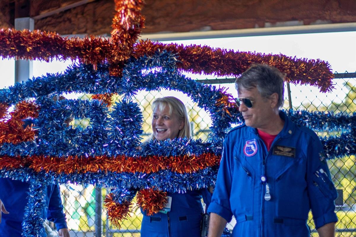UFHealth's tweet photo. Happy Homecoming @UF! Here's a behind the scenes photo from The Alligator of Lily Irwin and Wade Jones from our @ShandsCair team working on their float for the #UFParade. https://t.co/Srtz7TFzjy