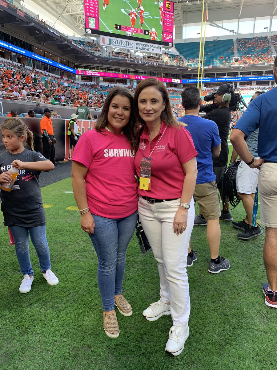 SylvesterCancer's tweet photo. Honoring #breastcancer survivor Cookie Ornelas and her doctor @atperez_md at #UMPinkGame. Dir. @DrSDNimer receives a pink jersey from @CanesFootball with the #71 for being the 71st #NCIDesignated cancer center in the US. He’s joined by @julio_frenk @FeliciaKnaul @EAbrahamUHealth https://t.co/WpNxPluJta