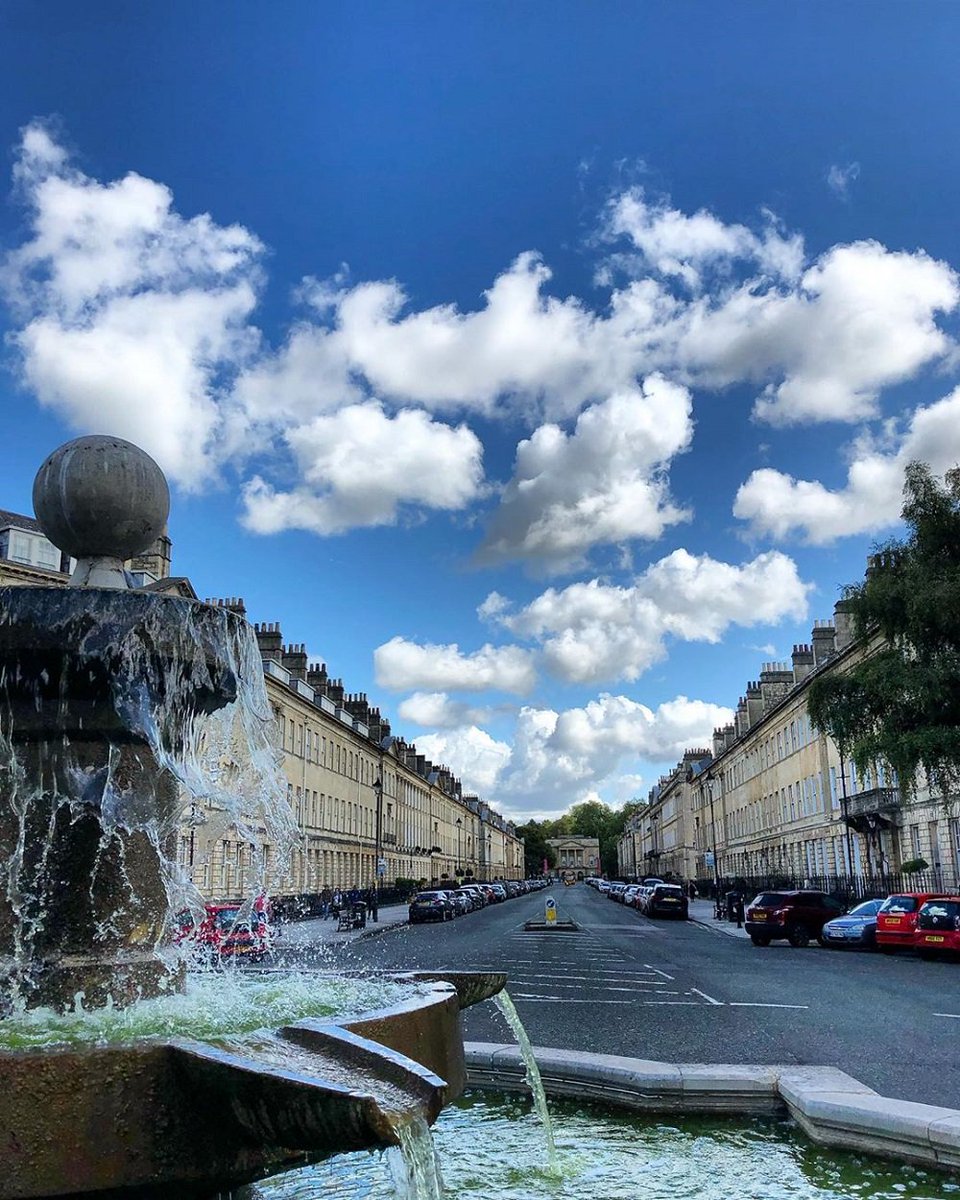 The fountain on Laura Place with a backdrop of fluffy clouds. ⛲️☁️