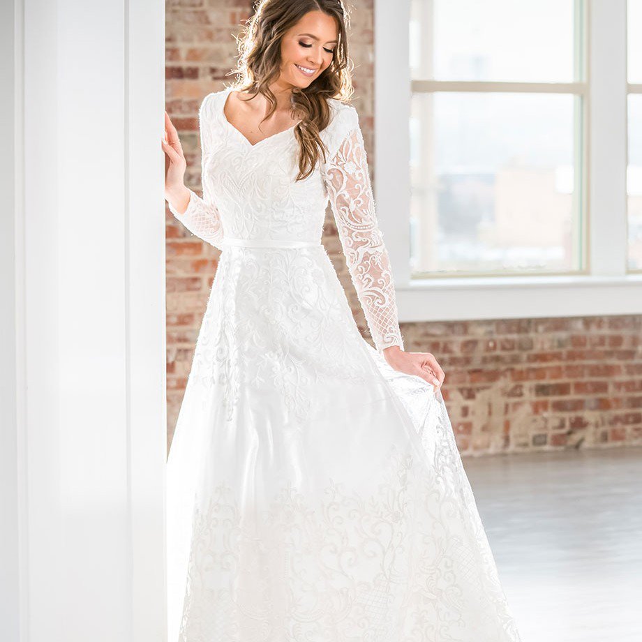 MalmroseB's tweet photo. This perfectly classic and traditional lace and tulle full A-line gown offers illusion lace long sleeves over modesty cap sleeves, a curved V-neckline, a satin natural waistband, a back zipper, and a court train. https://t.co/lOaYiZ6Zqz