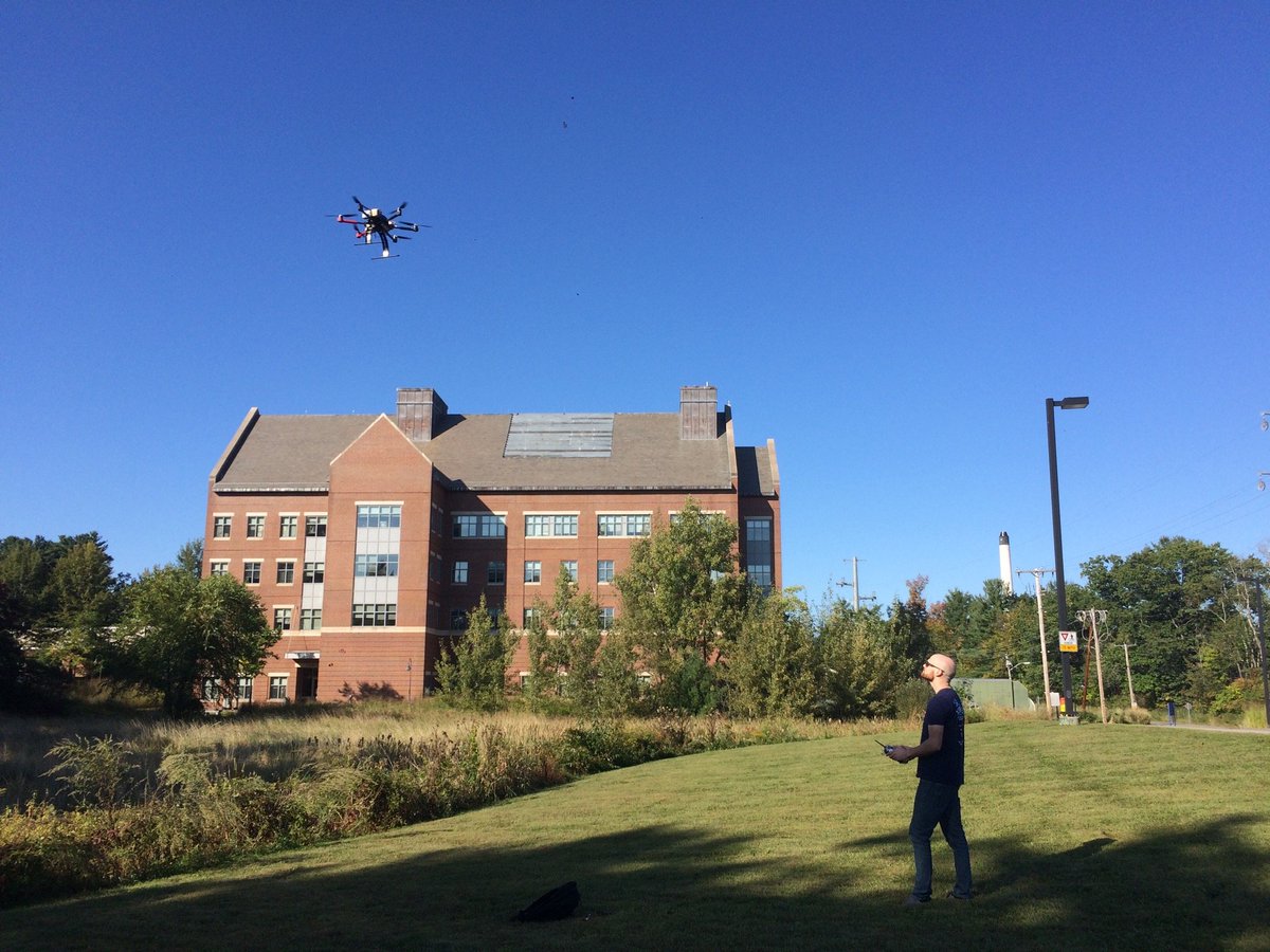 Dylan Kelly of UNH NRESS PhD program flying our older XM6 in front of Greg Hall.  This is work that will use a UAS-mounted pyranometer to measure the reflected solar radiation of different landcovers. Dylan is working with Meghan Howey, Liz Burakowski, and Michael Palace.