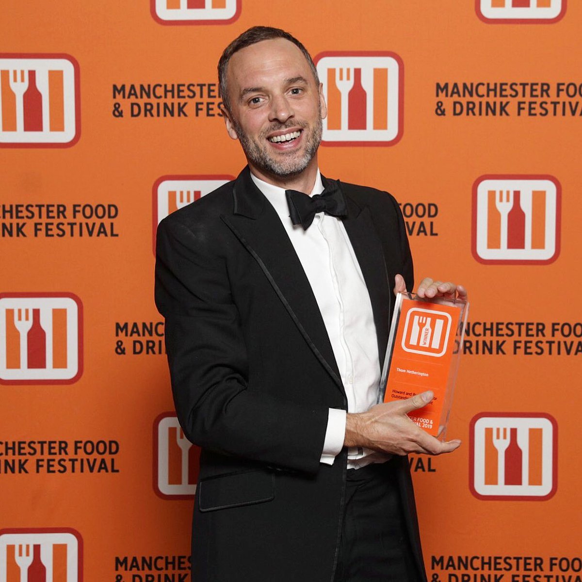 ThomHetheringto's tweet photo. It appears, possibly due to an administrative error, that I've won the @mfdf2019 Outstanding Achievement Award. I'm gobsmacked and grateful to say the least. I couldn't have done it without my family, friends, Team @NRBManchester. It's been a tough year, and this means so much. https://t.co/RQRZo4R6dn