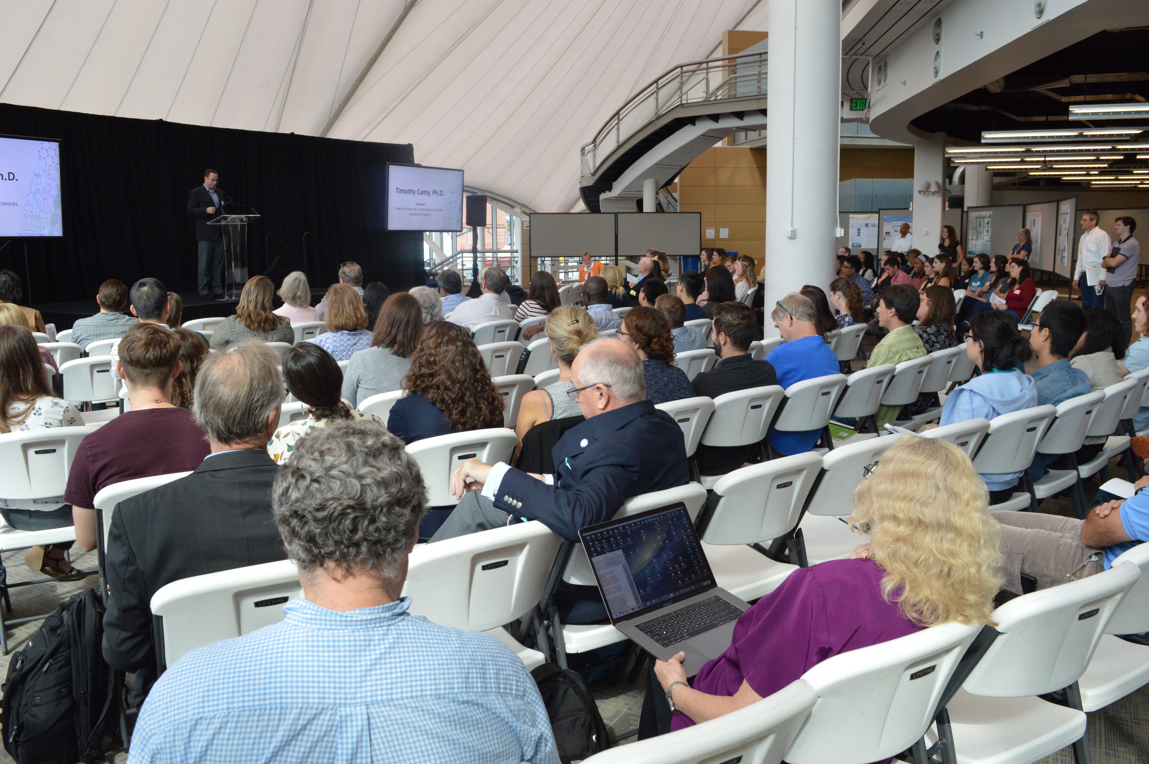 presenter on stage in front of an audience