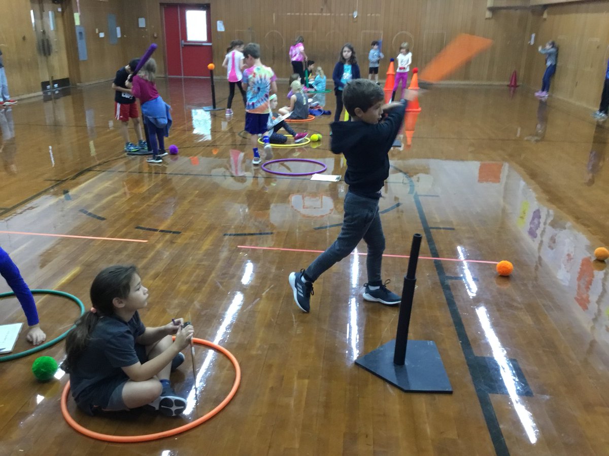 MrDarlingPE's tweet photo. Stuck inside? No problem!  Third grade students striking a stationary ball. Skill check coming up....peers are helping to check our smooth swing! @mes_rockets https://t.co/yey4bIvn4M