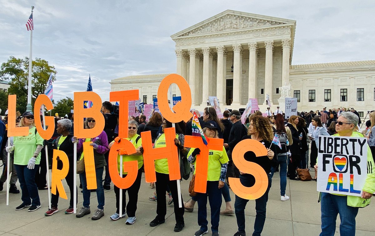 Large letters in front of the Supreme Court spell out the words “LGBTQ RIGHTS.” Another sign reads “Liberty for all.”