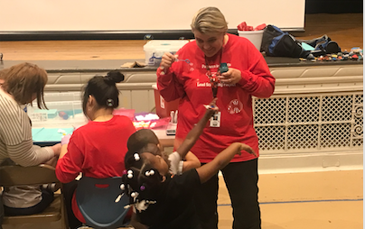 CLEMetroSchools's tweet photo. Carol Pennington, mgr, nursing &amp; health services, uses bubbles to entertain children waiting for lead screening at Wilbur Wright. CMSD nurses &amp; CWRU nursing students hope to test 3- to 6-year-olds in all elementary schools in response to the citywide lead poisoning problem. https://t.co/ruXzyl7CuG