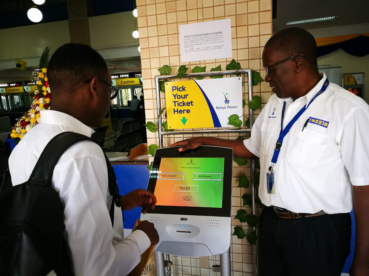 KenyaPower's tweet photo. Day 3 of #CSWeek2019 our staff Jacob Odongo spreads the
#MagicalService to a customer on how to navigate the Queue Management System (QMS) ticket kiosk at Stima Plaza banking hall. ^ EN https://t.co/imM3SAAJEU