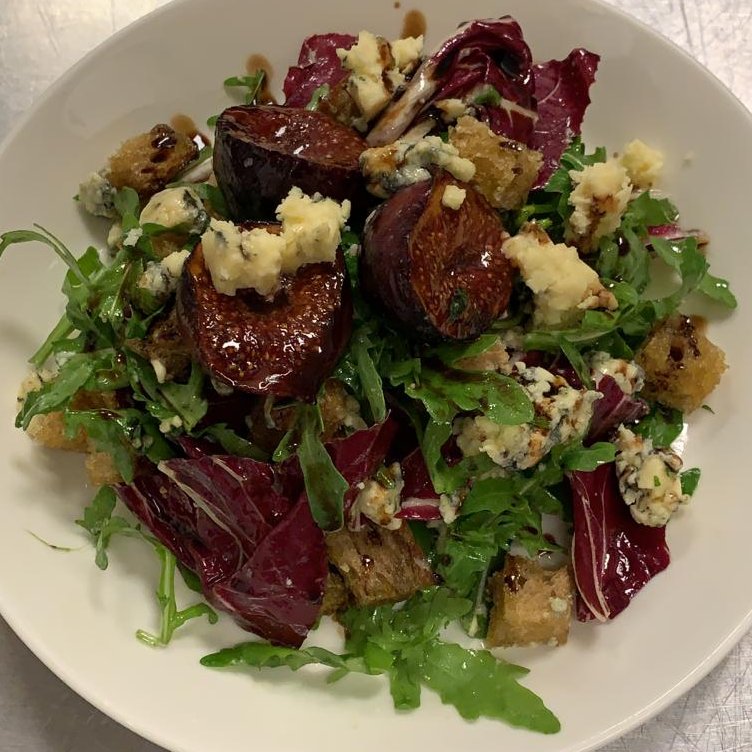 Pop in and treat yourself to this delicious salad: Roasted figs, crouton, rocket, chicory, a balsamic glaze and - of course! - freshly crumbled Colston Bassett Stilton. 

The tangy, salty, fruitiness of the Stilton is complemented beautifully by the jammy figs... 

Yum!