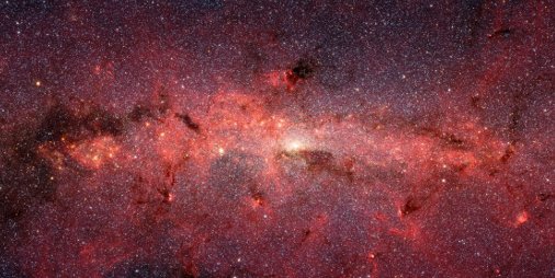 A field crowded with stars and splotched with dark dust patches