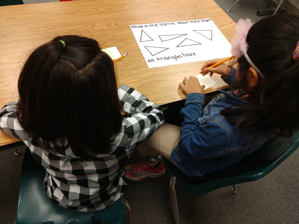 First grade Young Scholars working together to start their M2 unit.  It is so cool to hear them use words like "vertices!"  They are working hard to build their math vocabulary.