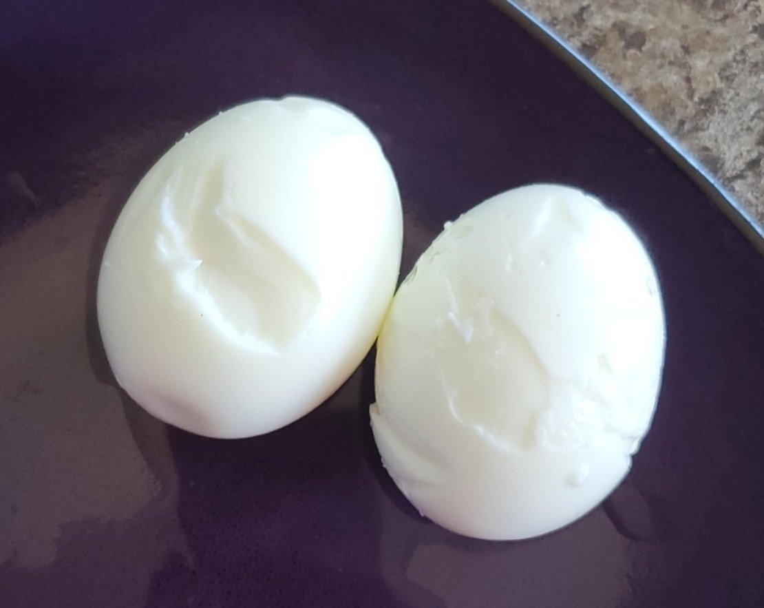Peeled eggs that have been completely demolished by my ineptness.