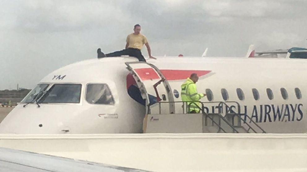 Activist climbs plane as Extinction Rebellion takes protest to London airport ile ilgili görsel sonucu