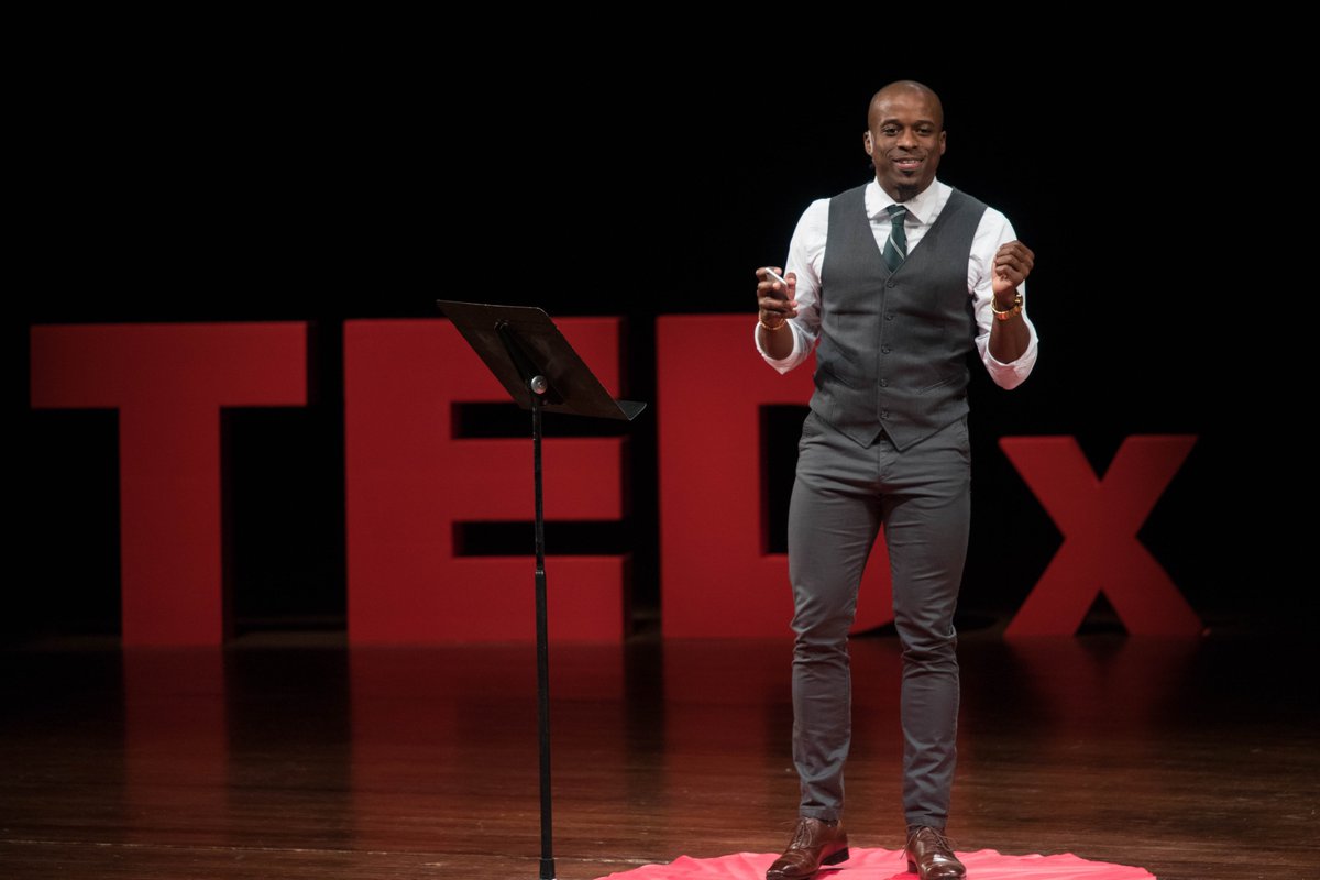 TEDx speaker speaking to crowd at TEDx in 2018.
