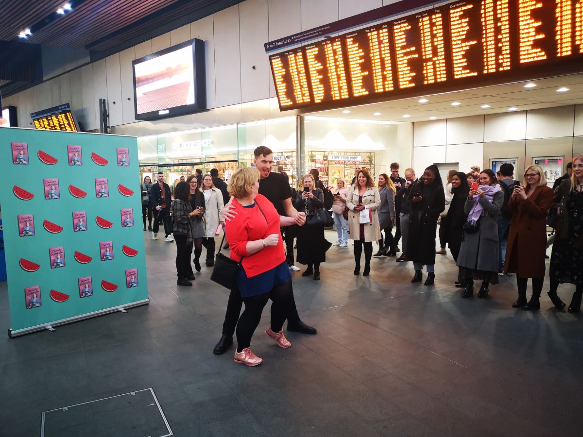 thebookseller's tweet photo. .@HQstories brought London Bridge station to a standstill at lunchtime today with a Dirty Dancing-inspired publicity stunt to promote comedian @KatyFBrand’s new book: https://t.co/N3lxJPCF15 https://t.co/oriD60pLg2