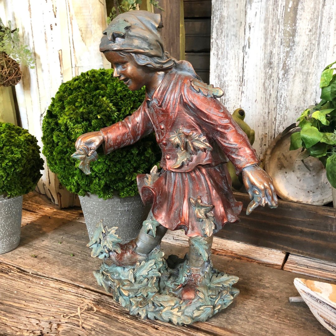 Child playing in leaves hand-crafted statuary made from polystone. Use in the front yard to greet visitors or in your garden for everyone to enjoy. Perfect fall outdoor accessory.

#lifelikestatue #lawnandgarden #figurine #outdoorsafe #southportncgardencenter #allinbloomsouthport