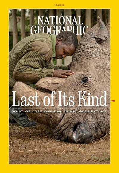 magazine cover for national geographic. A man hugging a rhino