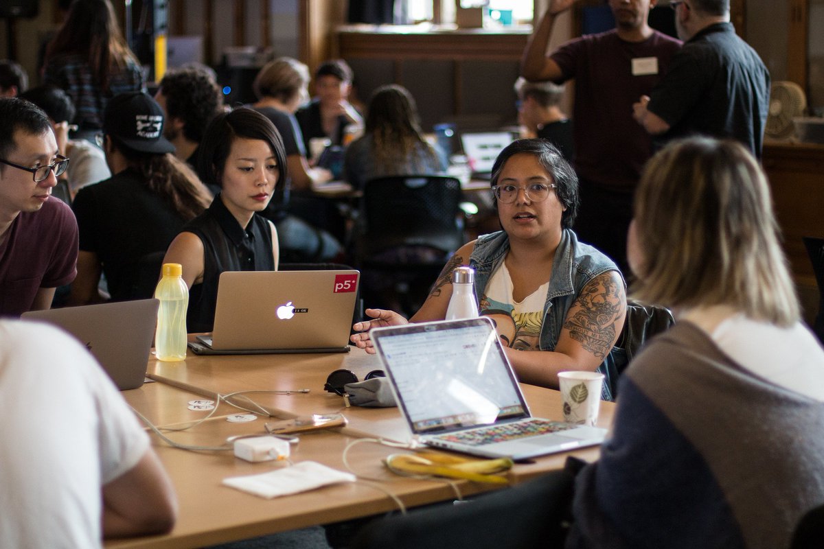 group of participants talking across laptops