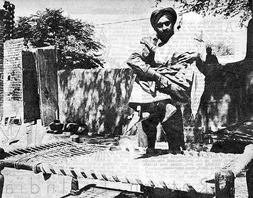 39 #RunawayPakArmy1965 - Deserted by all, on the Pakistani retreat from Salian village in the Sialkot sector, Hasana Begum, 85, is helped to her cot outside her small home by Sikh soldier.