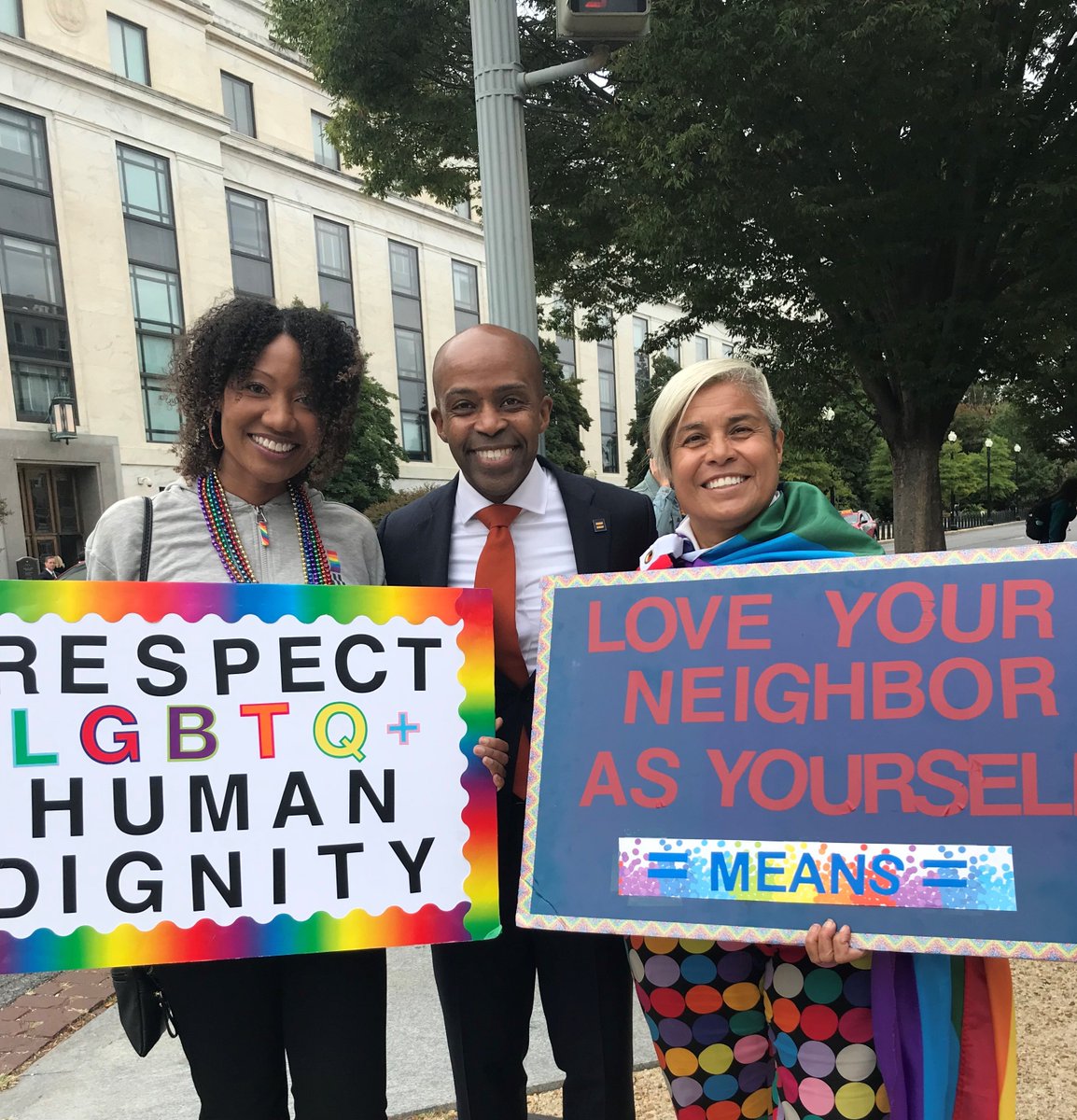 HRC President Alphonso David with HRC members and their pride signs