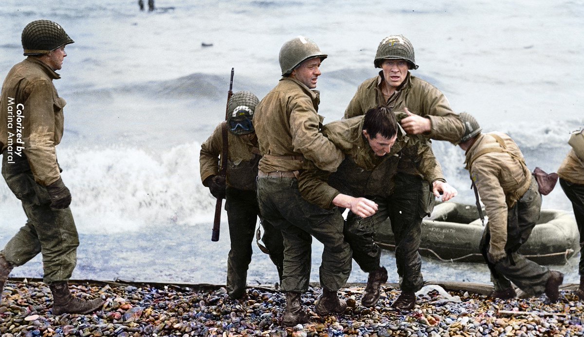 Medics from the 5th and 6th Engineer Special Brigade helping wounded soldiers onto Omaha Beach on June 6, 1944.