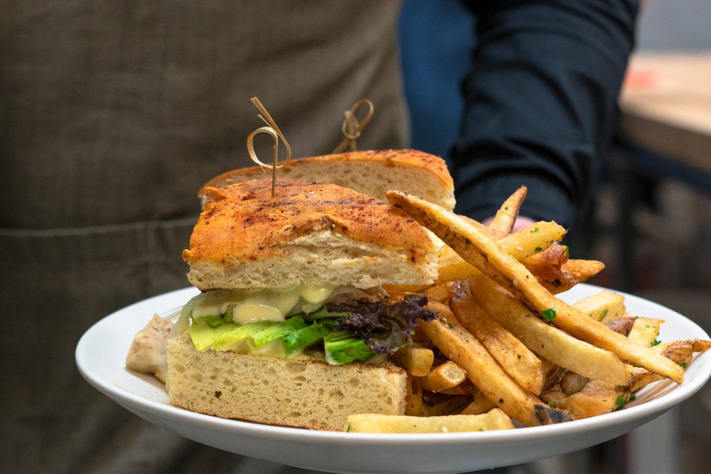 Our savory grilled chicken sandwich on freshly baked focaccia with avocado, lolla rosa and gruyère is what weekends are all about! #Delicious #SandwichTime #SantuariLa