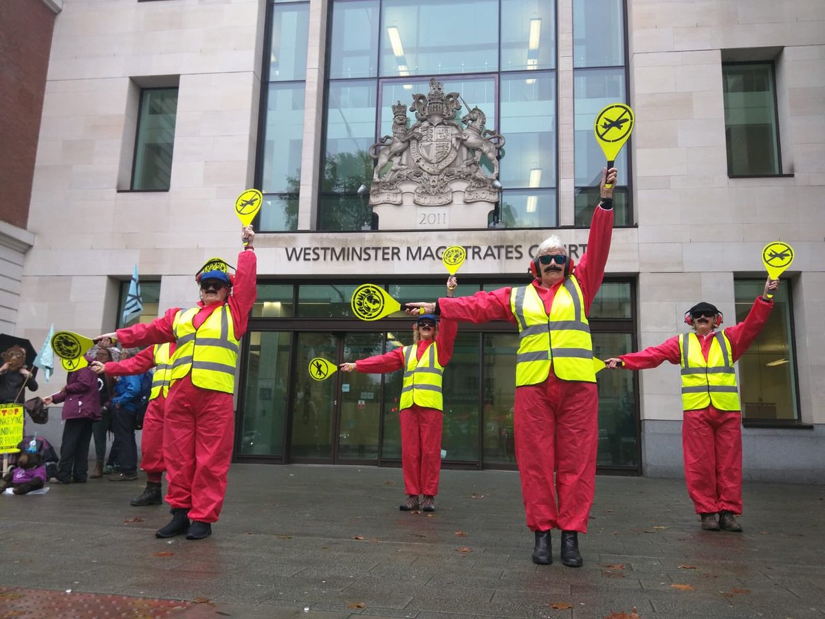 #LandingCrew performers outside #Westminster #MagistratesCourt as James Brown, the blind Paralympian medallist, arrested after climbing on a plane at City airport, denies causing a public nuisance. 

Art meets law meets protest meets bravery meets #ClimateEmergency