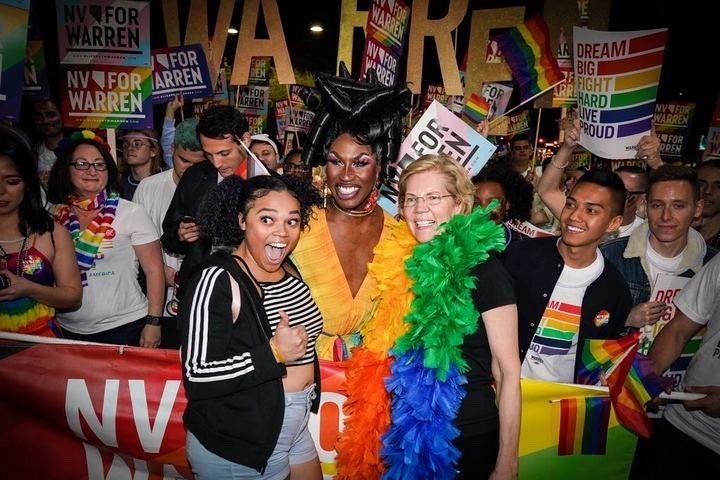 Elizabeth Warren and Shea Coulee smile and pose with supporters at the Las Vegas Pride Parade. 