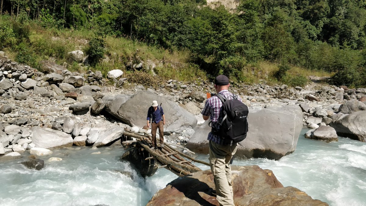 basanta58_raj's tweet photo. Crossing Himalayan river is not always fun. @WSchwanghart is trying to fix his legs in this wooden bridge. #pokhara #setiriver https://t.co/cmGcfdamGg