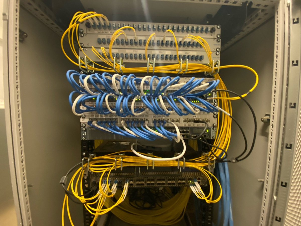 Photo of the Allmandring 4 dormitory core router, 2 access switches and lots of optical singlemode fibers.
