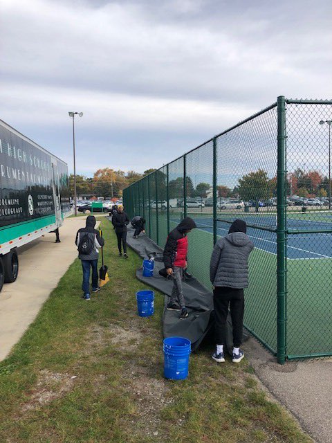FrogForce's tweet photo. Frog Force volunteers out today at the Novi HS Tennis courts, removing wind screens and getting the courts ready for winter.  Finished in time to beat the rain! @NCSD #morethanrobots https://t.co/ZFBuUKXVAL