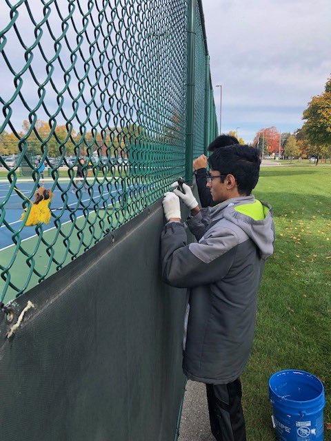 FrogForce's tweet photo. Frog Force volunteers out today at the Novi HS Tennis courts, removing wind screens and getting the courts ready for winter.  Finished in time to beat the rain! @NCSD #morethanrobots https://t.co/ZFBuUKXVAL