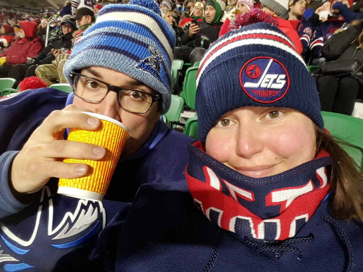 MegInks's tweet image. Bundled up and ready for the game! Hubby has his @ManitobaMoose jersey and hat! 
#heritageclassic #WinnipegJets #GoJetsGo @NHLJets