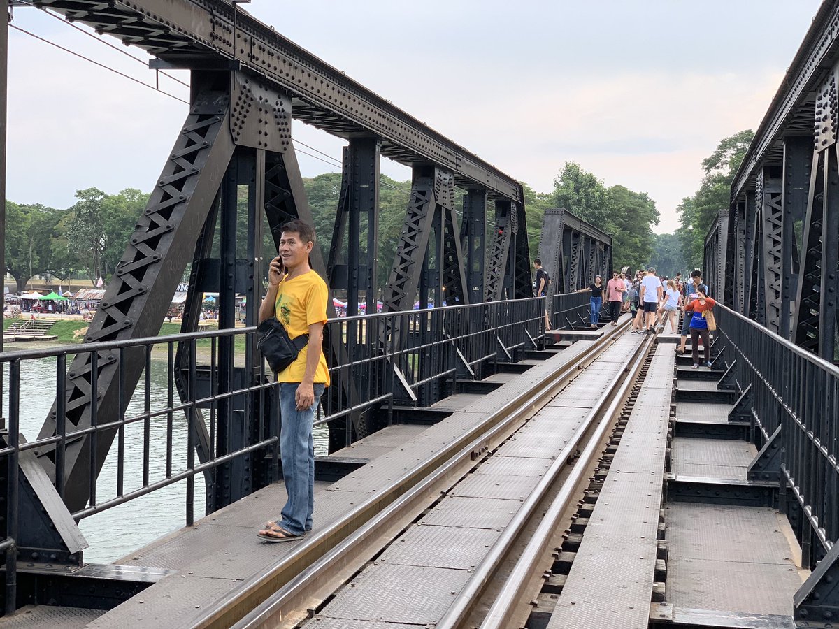 Starting from Kanchanaburi side, the bridge has arched trusses that give way to flat ones. The flat ones were installed after the Allied bombing. Strangely enough, the builder’s plate read: “Yokogawa Bridge Works: Tokyo, Japan”. &ndash; bei  สะพานข้ามแม่น้ำแคว (The Bridge of the River Kwai)