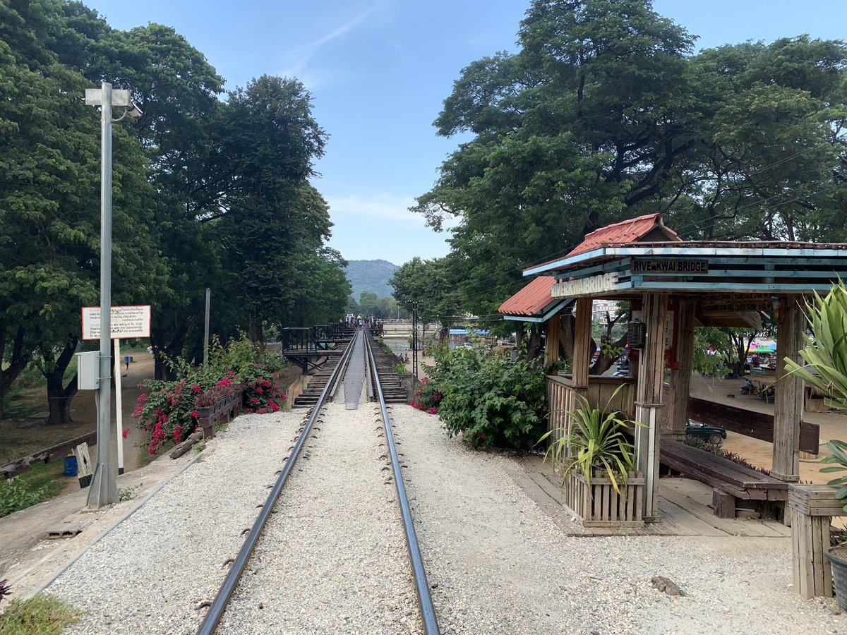 On the Nam Tok side, there is a small hut that tells distances to various places. Visitors are welcomed by colorful plants on both sides of the bridge. On this side, tourists usually do not venture due to risk of injury if they do not stay in the middle of the railway. &ndash; bei  สะพานข้ามแม่น้ำแคว (The Bridge of the River Kwai)