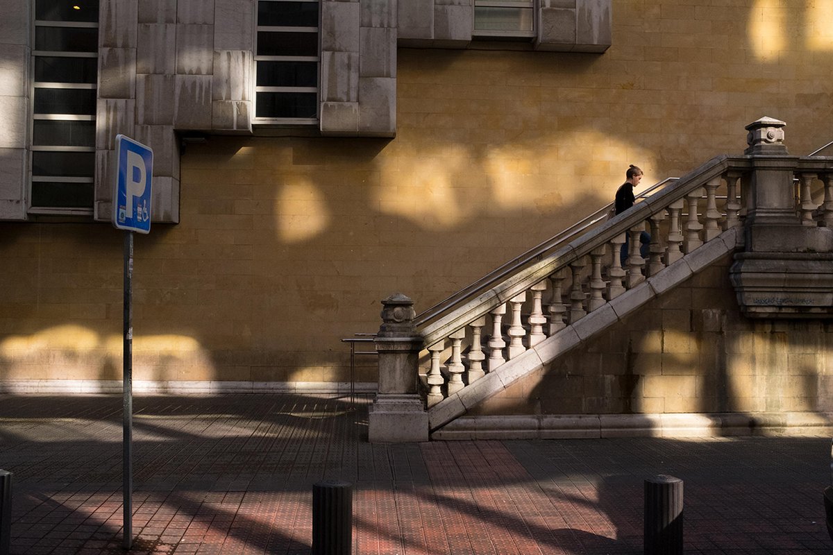 FujifilmUK's tweet photo. While in Bilbao teaching a Street Photography workshop, featured photographer this week, @NickTurpin, used his FUJIFILM X100F to capture the wonderful light bouncing off a single glass tower block to create a series of images. “This one was my favourite!�� https://t.co/egN1m5LdWY
