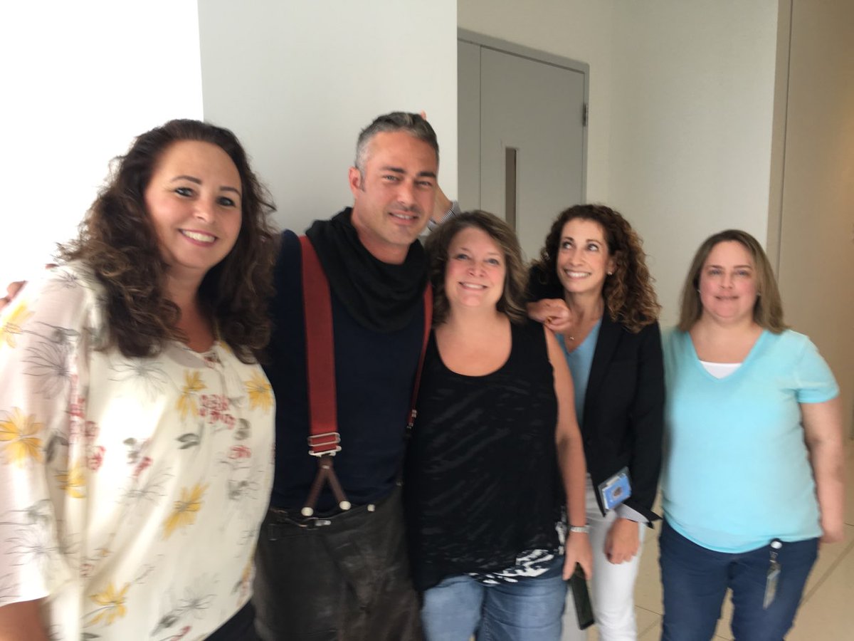 Zenfur's tweet photo. Flashback to that time when Chicago Fire invaded our building and I tried to give Taylor Kinney rabbit ears. #imtooshort #doover #IAmZurich #chicagofire @zurichna https://t.co/Wz34Q5Mk5b